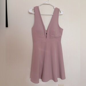 Mauve mini dress with deep neckline.
